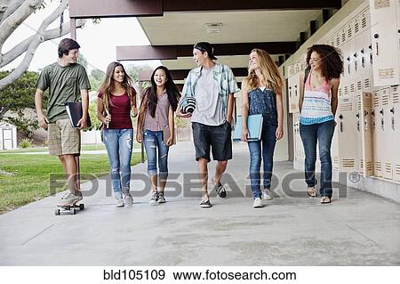 Stock Photo - School friends walking in portico. Fotosearch