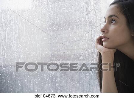 Serious Hispanic teenager looking out window View Large Photo Image Stock Image - Serious Hispanic teenager looking out window. Fotosearch