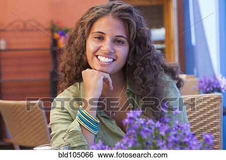 Smiling African American woman with hand on chin View Large Photo Image Stock Photograph - Smiling African American woman with hand on chin. Fotosearch
