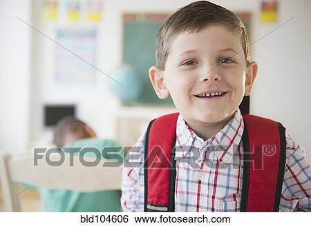 Stock Photograph - Smiling Caucasian boy in classroom. Fotosearch