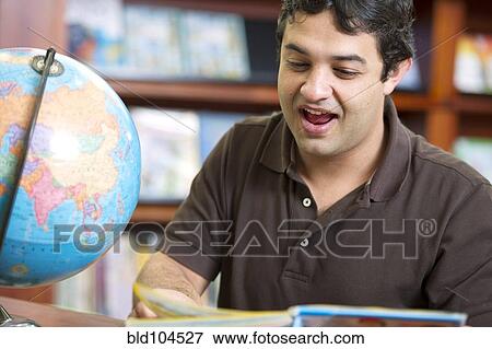 Stock Photo - Smiling Colombian man in library. Fotosearch