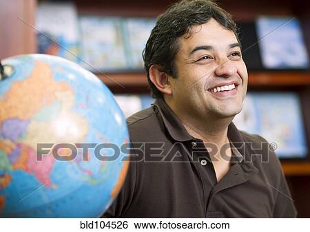 Smiling Colombian man in library View Large Photo Image Stock Photograph - Smiling Colombian man in library. Fotosearch