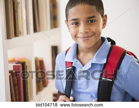 Smiling Hispanic boy carrying backpack View Large Photo Image Stock Photo - Smiling Hispanic boy carrying backpack. Fotosearch