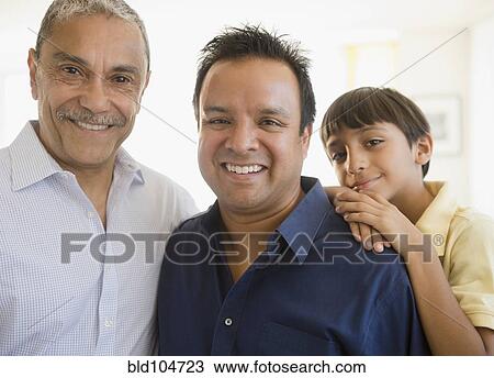 Stock Image - Smiling Hispanic grandfather, father and son. Fotosearch