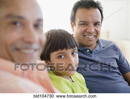 Stock Image - Smiling Hispanic grandfather, father and son. Fotosearch
