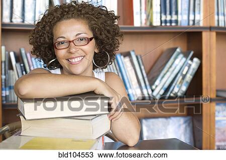 Smiling Hispanic woman in library View Large Photo Image Stock Image - Smiling Hispanic woman in library. Fotosearch