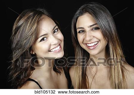 Stock Image - Smiling mixed race friends. Fotosearch