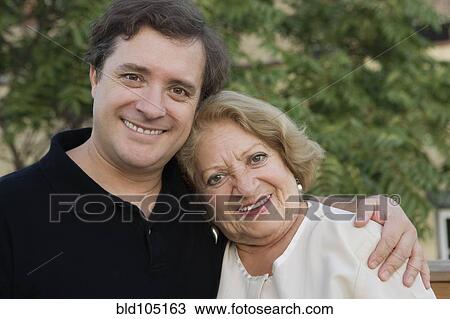 Stock Image - Smiling mother and adult son. Fotosearch