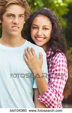 Stock Image - Smiling teenage couple. Fotosearch