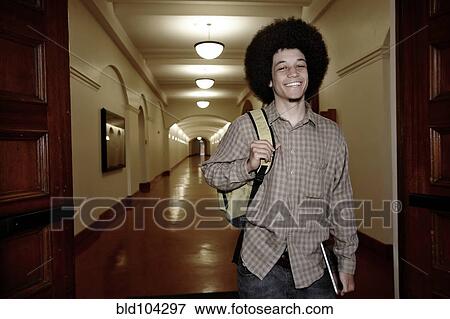 Student with afro walking in corridor View Large Photo Image Stock Photo - Student with afro walking in corridor. Fotosearch