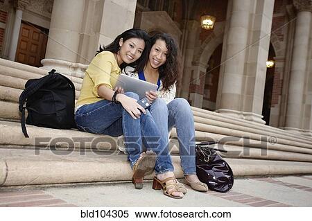 Students looking at digital tablet together View Large Photo Image Stock Photography - Students looking at digital tablet together. Fotosearch