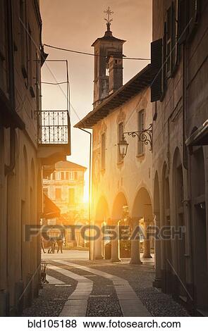 Stock Photo - Sun shining in quaint alley. Fotosearch