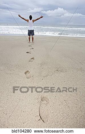 Stock Image - Young man enjoying the beach. Fotosearch