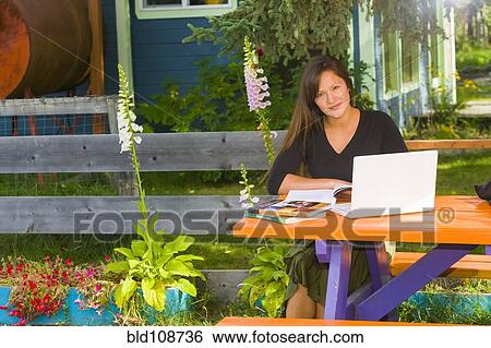 Alaskan woman doing homework at picnic bench View Large Photo Image Stock Photograph - Alaskan woman doing homework at picnic bench. Fotosearch