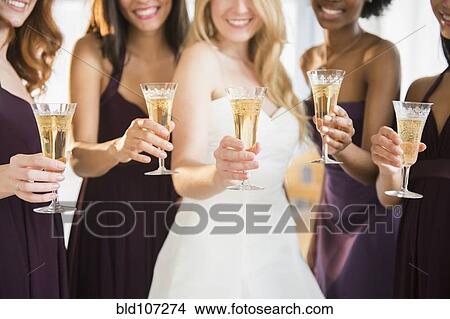 Picture - Bridesmaids and bride toasting with champagne. Fotosearch