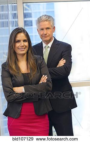 Stock Photo - Business people standing in office. Fotosearch