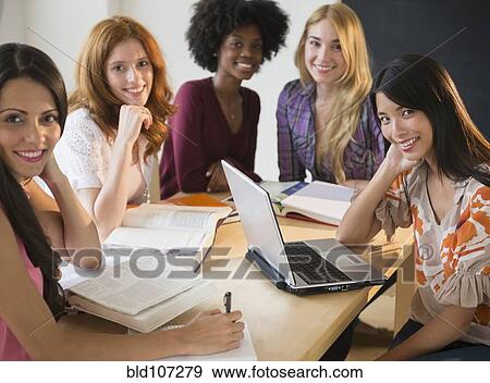 Businesswomen smiling in meeting View Large Photo Image Stock Photo - Businesswomen smiling in meeting. Fotosearch