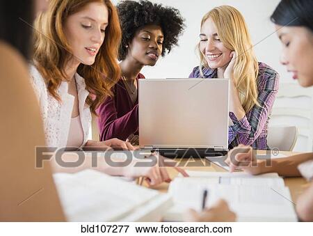 Businesswomen working together in meeting View Large Photo Image Stock Photo - Businesswomen working together in meeting. Fotosearch