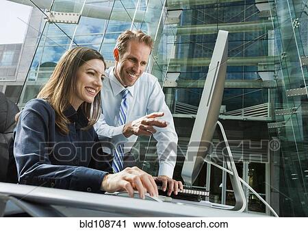 Caucasian business people working at computer View Large Photo Image Stock Image - Caucasian business people working at computer. Fotosearch