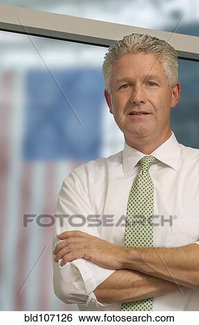 Stock Photograph - Caucasian businessman standing in office. Fotosearch
