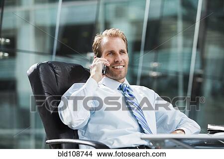 Caucasian businessman talking on cell phone View Large Photo Image Picture - Caucasian businessman talking on cell phone. Fotosearch