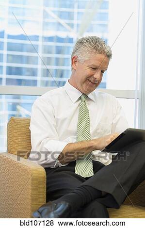 Caucasian businessman using tablet computer View Large Photo Image Stock Photo - Caucasian businessman using tablet computer. Fotosearch