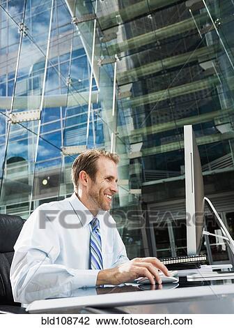 Caucasian businessman working on computer View Large Photo Image Stock Image - Caucasian businessman working on computer. Fotosearch
