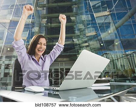 Caucasian businesswoman cheering at computer View Large Photo Image Stock Photo - Caucasian businesswoman cheering at computer. Fotosearch