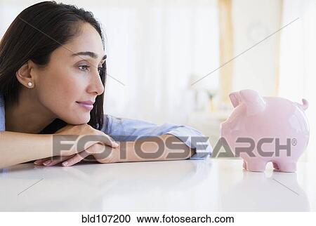 Caucasian businesswoman examining piggy bank View Large Photo Image Stock Image - Caucasian businesswoman examining piggy bank. Fotosearch
