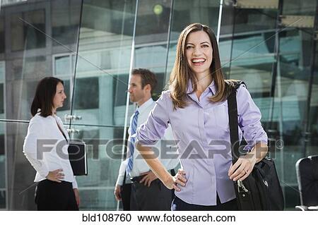 Stock Image - Caucasian businesswoman smiling in office. Fotosearch