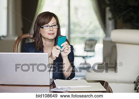 Caucasian businesswoman text messaging on cell phone View Large Photo Image Stock Photo - Caucasian businesswoman text messaging on cell phone. Fotosearch