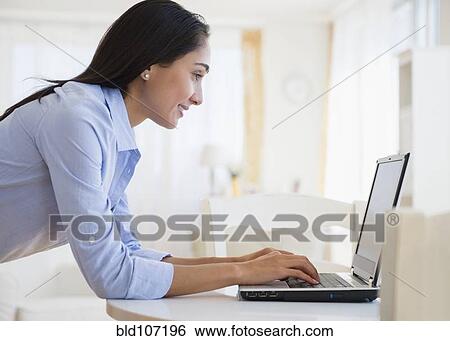Stock Photograph - Caucasian businesswoman using laptop. Fotosearch