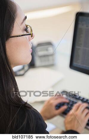 Stock Photography - Caucasian businesswoman working at desk. Fotosearch