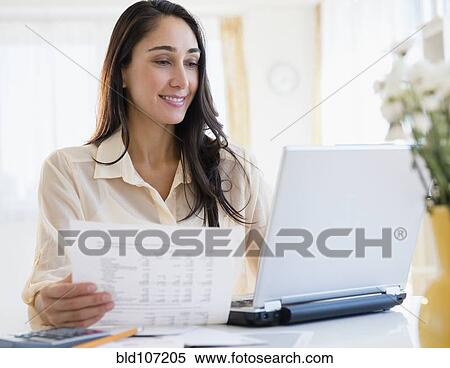 Stock Photography - Caucasian businesswoman working at laptop. Fotosearch