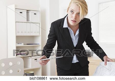 Stock Image - Caucasian businesswoman working in office. Fotosearch
