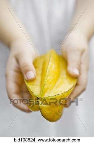 Picture - Caucasian child holding fruit. Fotosearch