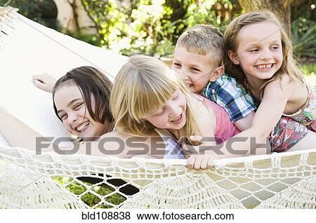 Caucasian children playing in tree View Large Photo Image Stock Photo - Caucasian children playing in tree. Fotosearch
