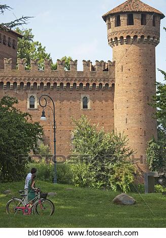 Stock Photograph - Caucasian couple looking at Italian tower. Fotosearch