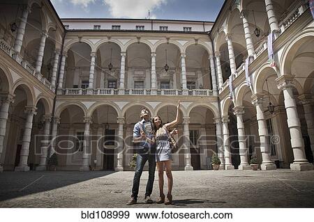 Caucasian couple sightseeing in plaza View Large Photo Image Stock Photo - Caucasian couple sightseeing in plaza. Fotosearch
