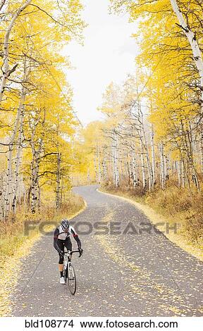 Picture - Caucasian cyclist on rural road. Fotosearch