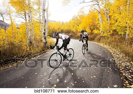 Caucasian cyclists on rural road View Large Photo Image Stock Image - Caucasian cyclists on rural road. Fotosearch
