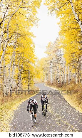 Stock Image - Caucasian cyclists on rural road. Fotosearch