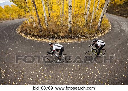 Stock Photo - Caucasian cyclists on rural road. Fotosearch