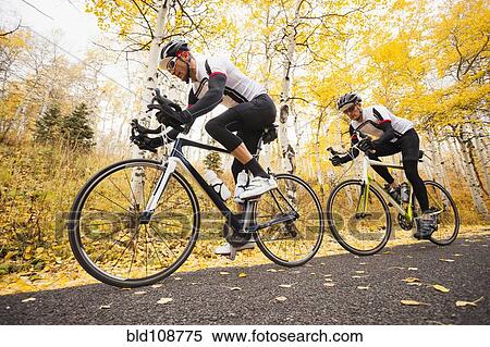 Caucasian cyclists on rural road View Large Photo Image Stock Photography - Caucasian cyclists on rural road. Fotosearch