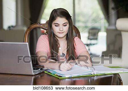 Stock Image - Caucasian girl doing homework. Fotosearch