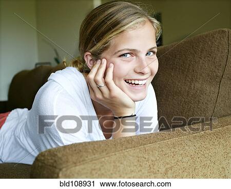Caucasian girl laying on sofa View Large Photo Image Stock Image - Caucasian girl laying on sofa. Fotosearch