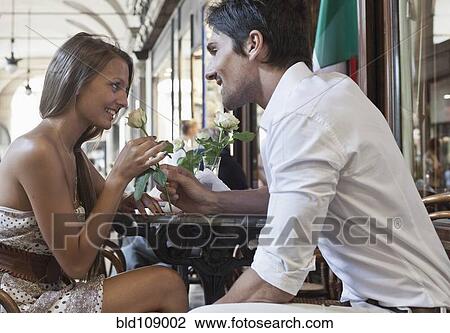 Caucasian man giving girlfriend a rose View Large Photo Image Stock Image - Caucasian man giving girlfriend a rose. Fotosearch