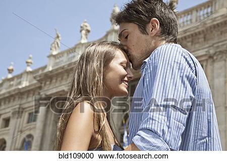 Stock Image - Caucasian man kissing girlfriend. Fotosearch