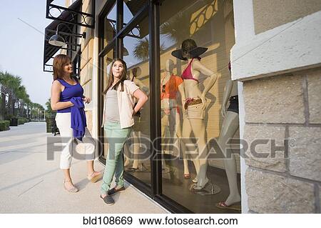 Stock Photo - Caucasian mother and daughter shopping together. Fotosearch