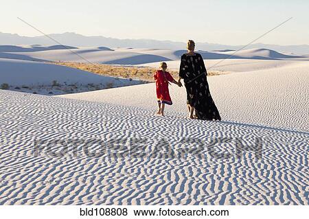 Caucasian mother and daughter walking in desert View Large Photo Image Stock Photo - Caucasian mother and daughter walking in desert. Fotosearch